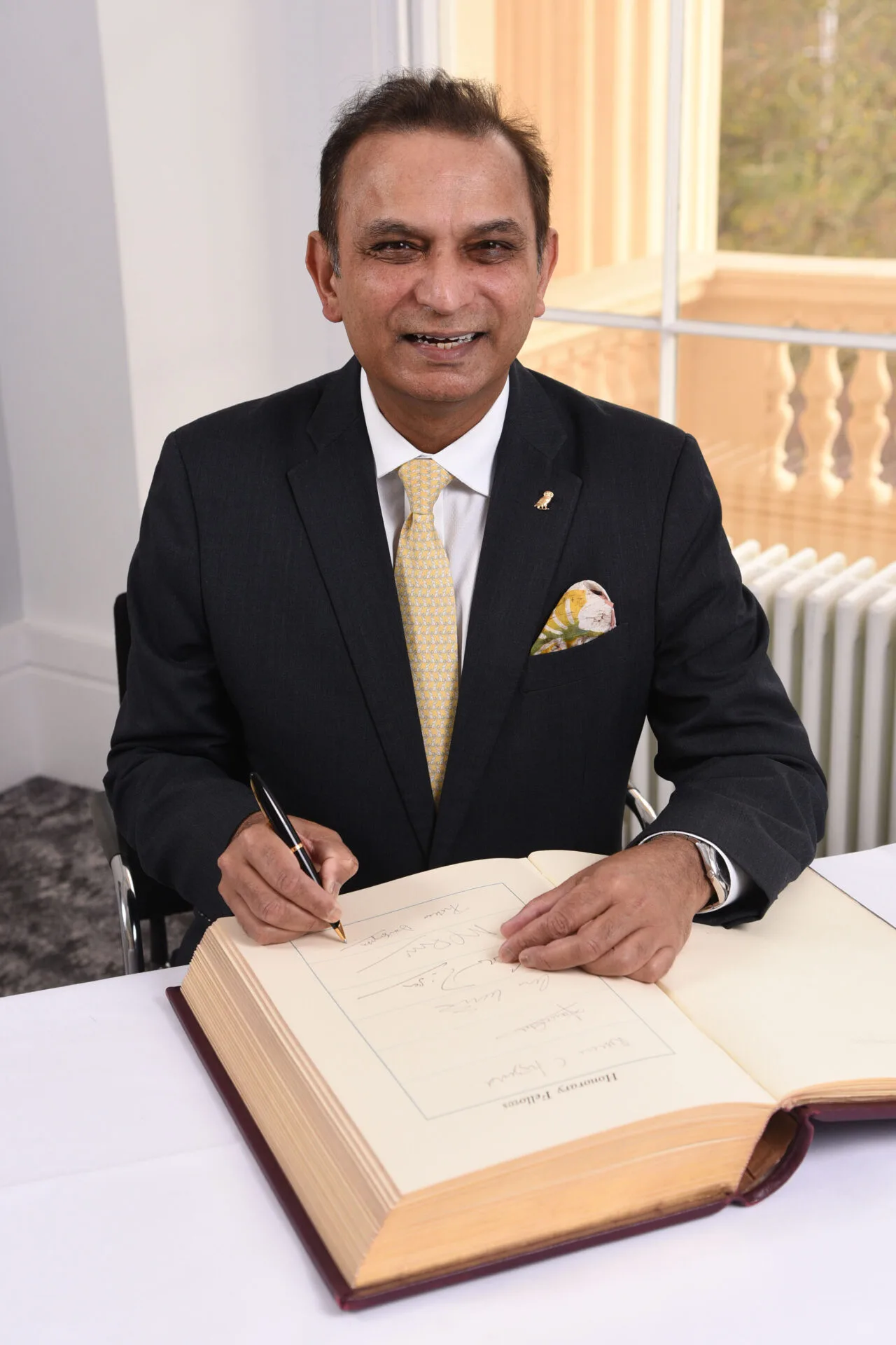 Professor Prokar Dasgupta signing the Honorary Fellows book